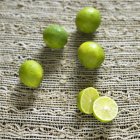 Ripe limes with halves — Stock Photo