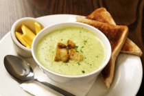 Herb soup with croutons in bowl — Stock Photo