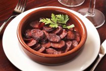 Chorizo with parsley in plate — Stock Photo
