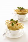 Closeup view of cream soup with a puff pastry lattice — Stock Photo