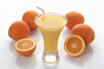 Smoothie and fresh oranges — Stock Photo