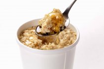 Porridge with honey in bowl — Stock Photo