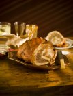 Closeup view of Turducken on platter and wooden table — Stock Photo