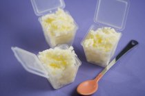 Grated ginger in plastic containers with a spoon — Stock Photo