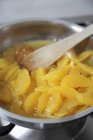 Closeup view of caramelizing orange slices in pot — Stock Photo