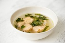 Broth with salmon and spinach — Stock Photo