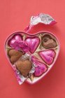 Pink chocolates in heart-shaped box — Stock Photo