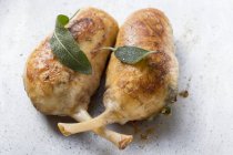 Stuffed chicken legs with sage leaves — Stock Photo