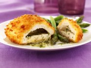 Chicken kiev with garlic butter, herbs and asparagus on white plate — Stock Photo