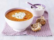 Carrot soup with sour cream — Stock Photo