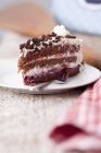 Closeup view of Black Forest gateau piece with fork on plate — Stock Photo