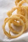 Onion rings on kitchen paper — Stock Photo