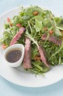 Steak salad with dressing — Stock Photo