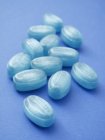 Closeup view of blue sweets on blue surface — Stock Photo