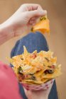 Woman holding nachos — Stock Photo