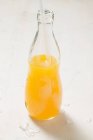 Orange juice in bottle — Stock Photo