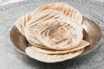 Grilled flatbreads on metal plate — Stock Photo