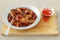 Sausage pieces in sauce — Stock Photo
