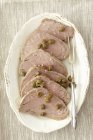 Sliced of roasted beef with capers — Stock Photo