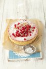 Redcurrant cheesecake on paper — Stock Photo