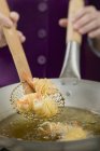 Deep-frying noodle-wrapped prawns — Stock Photo