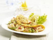 An omelette with king prawns and asparagus on white plate  over towel — Stock Photo