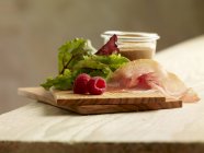 Lettuce with Parma ham and dressing — Stock Photo