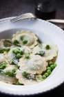 Ravioli pasta with peas and parmesan — Stock Photo