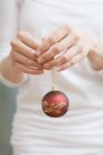 Woman holding Christmas bauble — Stock Photo