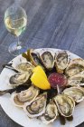 Fresh oysters and glass of white wine — Stock Photo