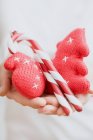 Hands holding Christmas tree ornaments — Stock Photo