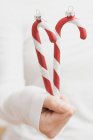 Hand holding candy canes — Stock Photo