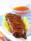 Spare ribs on lettuce leaves — Stock Photo