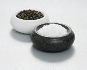 Salt and pepper in dishes — Stock Photo