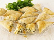 Closeup view of whole and broken stuffed puff pastry pockets — Stock Photo