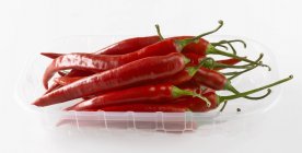Chillies in plastic tray — Stock Photo