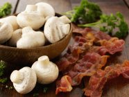 Closeup view of mushrooms with fried bacon and herb — Stock Photo