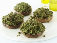 Closeup view of mushrooms filled with Pesto — Stock Photo