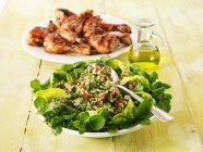 Closeup view of Tabbouleh and grilled chicken legs — Stock Photo