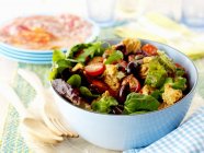 Panzanella with olives in blue bowl — Stock Photo