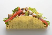 Closeup view of one chicken Taco on white surface — Stock Photo