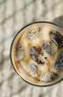 Closeup top view of iced coffee in glass — Stock Photo