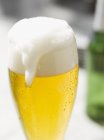 Glass of lager with foam — Stock Photo