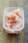 Preserved ginger in plastic container — Stock Photo