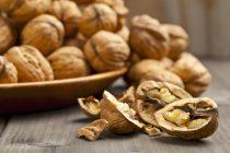 Whole and halved walnuts — Stock Photo