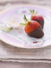 Strawberries dipped in dark chocolate — Stock Photo