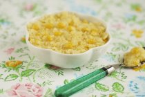 Closeup view of Polenta with fresh corn in a white dish and on spoon — Stock Photo