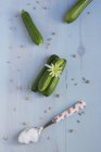 Fresh courgettes with salt in spoon — Stock Photo