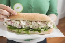 Closeup view of woman holding tuna sandwich — Stock Photo