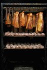 Bacon and Saumaisen dumplings in a smoking chamber — Stock Photo